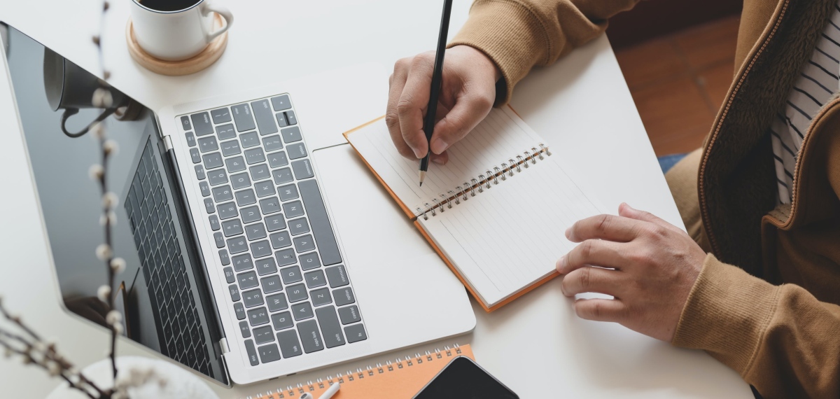 person-writing-on-notebook